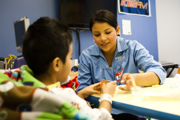 Volunteer with patient in the playroom