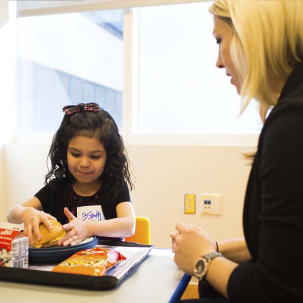 Clinical dietitian giving young girl lessons in good nutrition