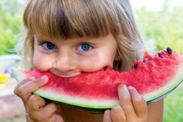 Young girl eating a watermelon
