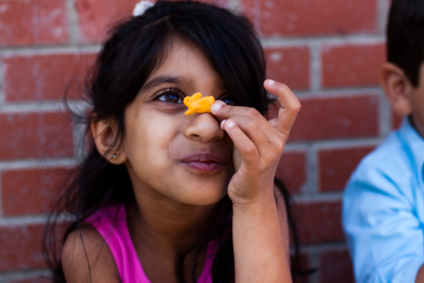 Girl holding a snack in her hand