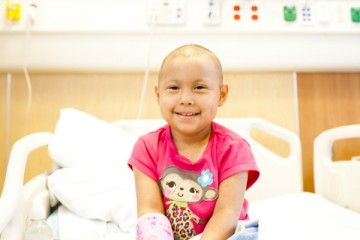 Cancer patient sitting on her hospital bed