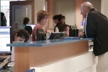 Man standing at nurses station counter