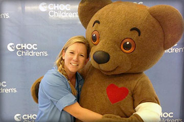 Joani, a volunteer at CHOC, with Choco Bear