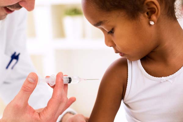 young girl gets vaccinated by doctor