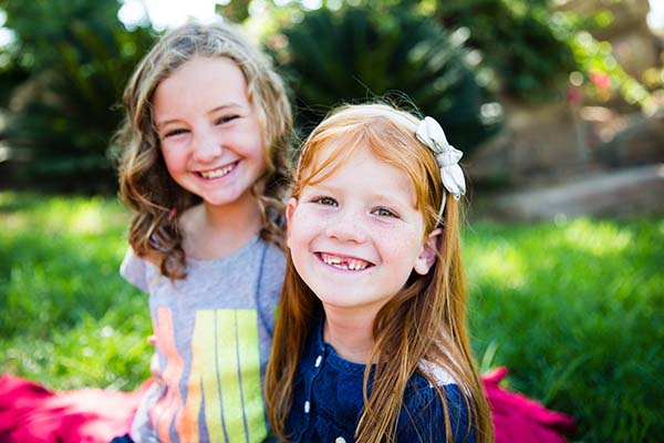 Smiling sisters together outside