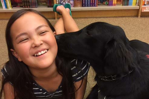 Smiling Ava with her dog