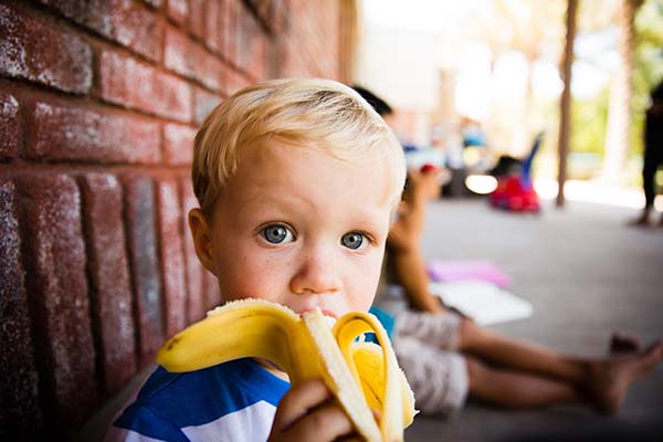 Young boy eating an apple