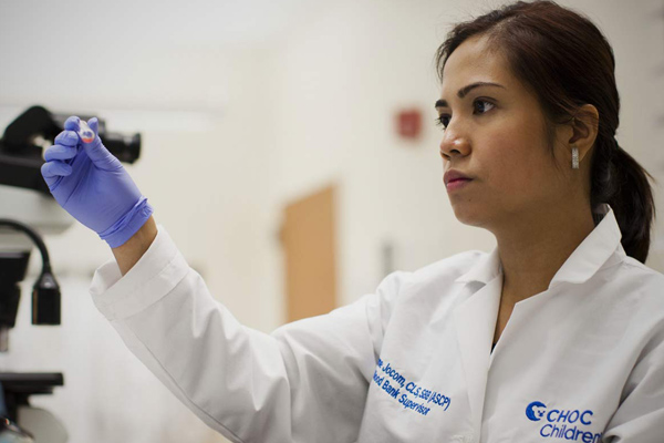 Scientist in laboratory holding test tube