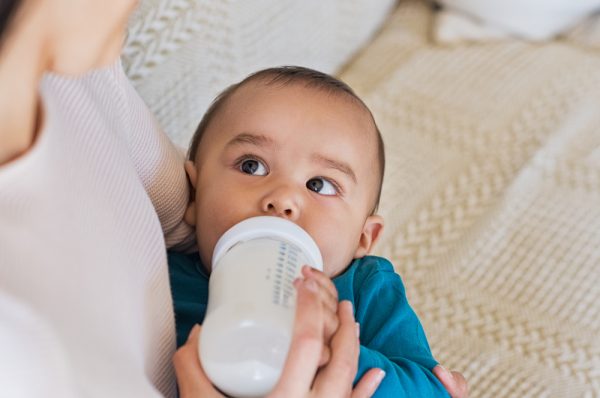baby boy drinking milk from bottle