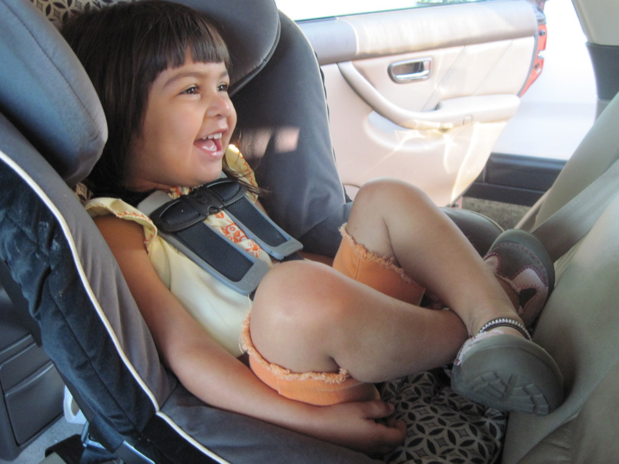 Smiling child in reverse facing child seat