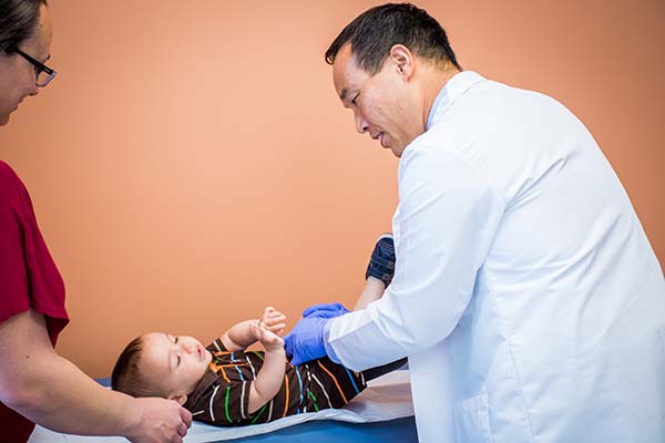 Physician examing toddler