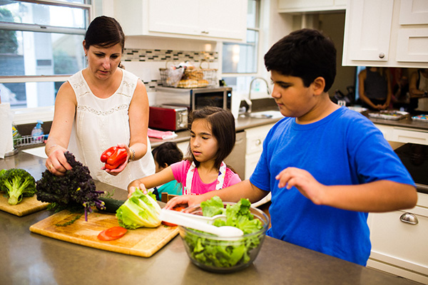 Family in the kitchen making a salad