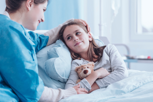 nurse with smiling young girl at hospital