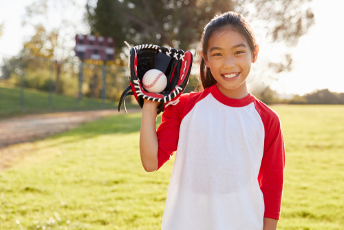 girl holding baseball mitt