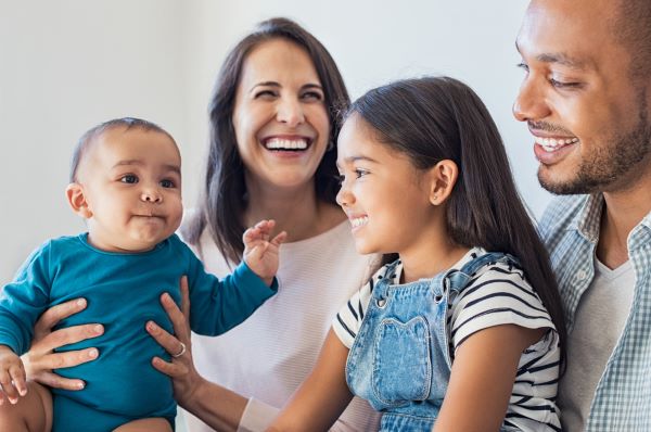 smiling parents with young children