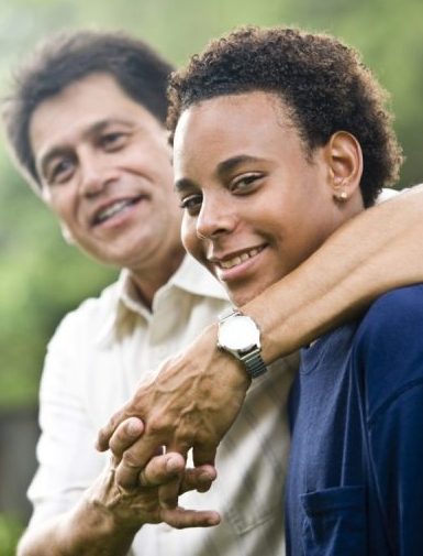 teenage boy smiling with father