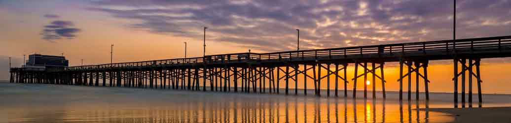 View of pier on the ocean at sunset