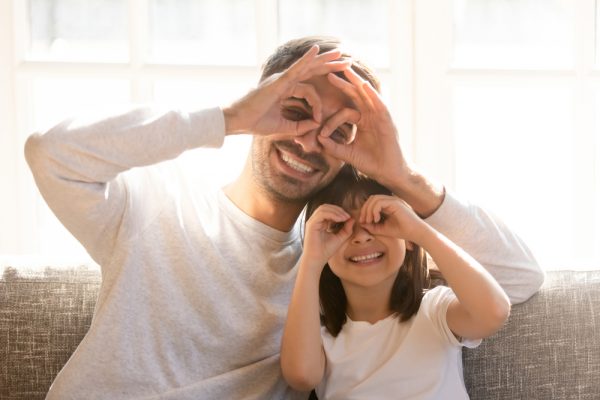 father and daughter seeing through hands like binoculars