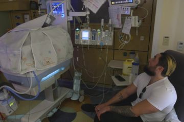 Dad at bedside of child in NICU