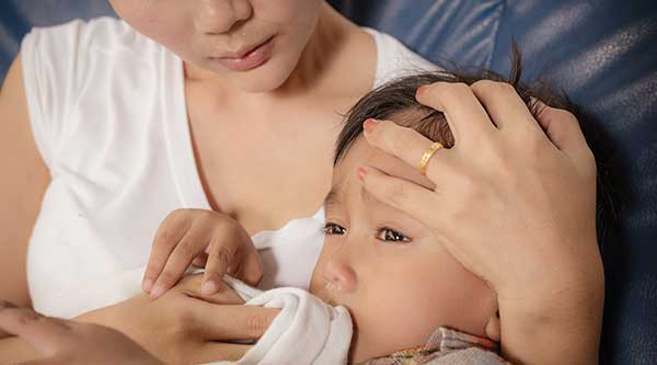 Mother comforting sick child