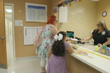 Mom and daughter at the clinic reception desk