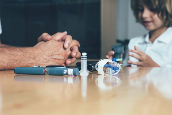 parent with diabetic equipment and son