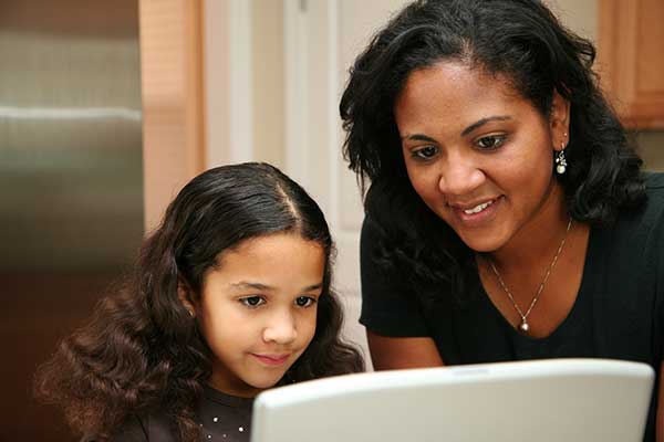 Mom with daughter looking at screen