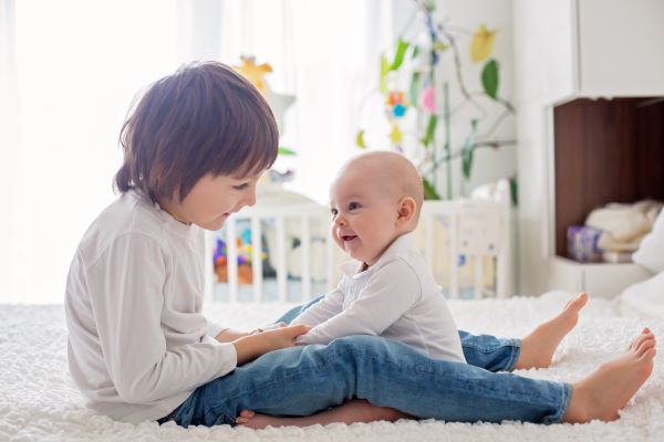 young boy playing with infant brother