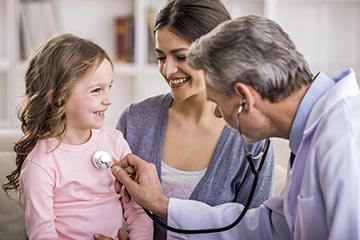 Mother and daughter with physician