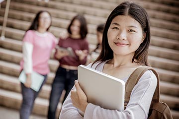 Smiling teen girl holding a tablet