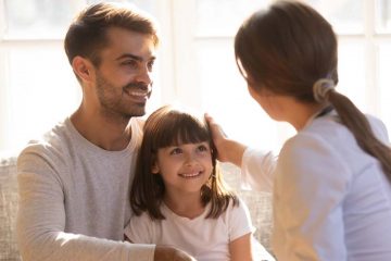 Pediatrician with patient and dad