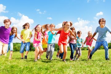 Children running outside on a field