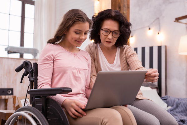 young girl with mom looking at a computer