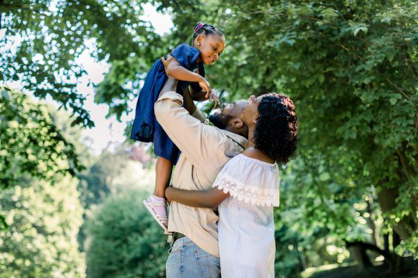 parents at the park playing with daughter