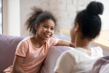 Daughter smiling and speaking to mother