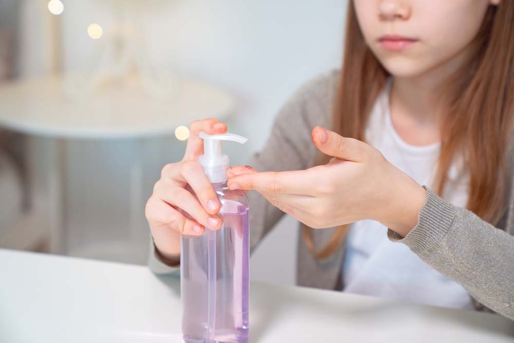 Teenage girl washes hands