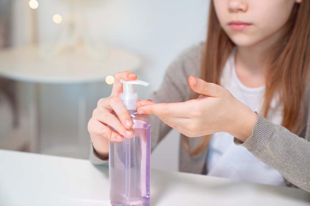 Teenage girl washes hands