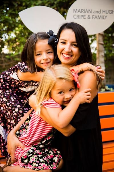 Amy Jennings, CHOC cancer survivor, smiling with her daughters