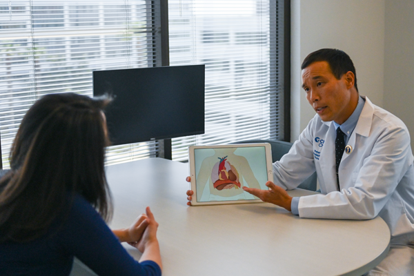 doctor showing picture to pregnant woman