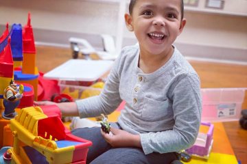 Boy plays while receiving Batten Disease treatment