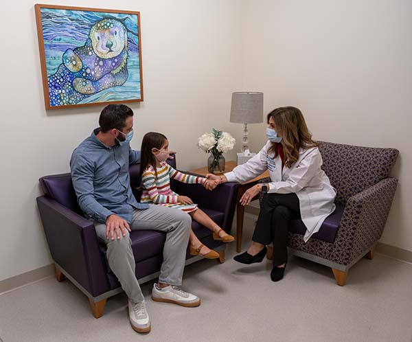 Pediatric radiologist holding hands with nervous patient