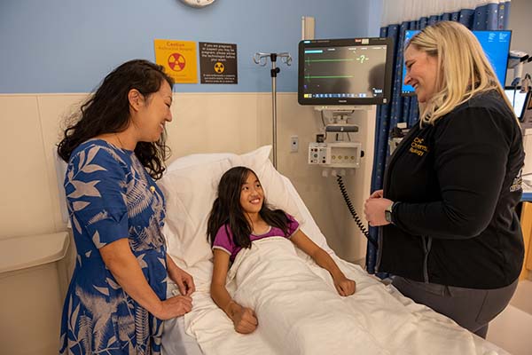 mom and young girl with nurse