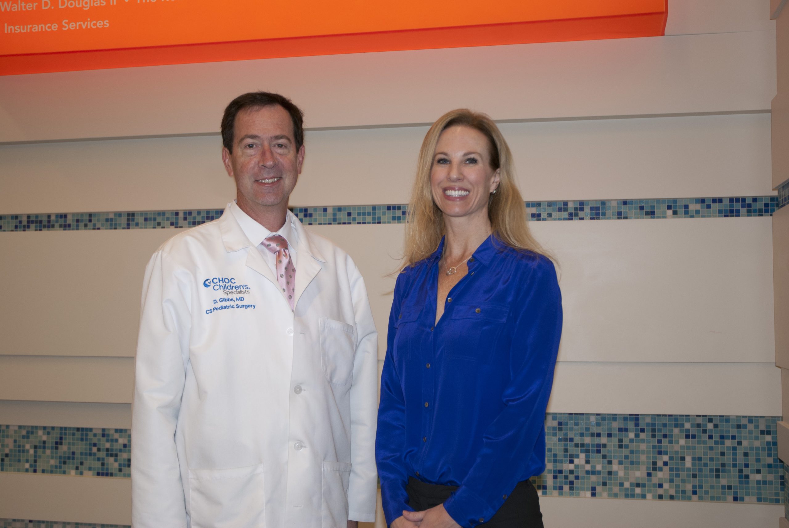 Physician in white coat and nurse manager in blue blouse