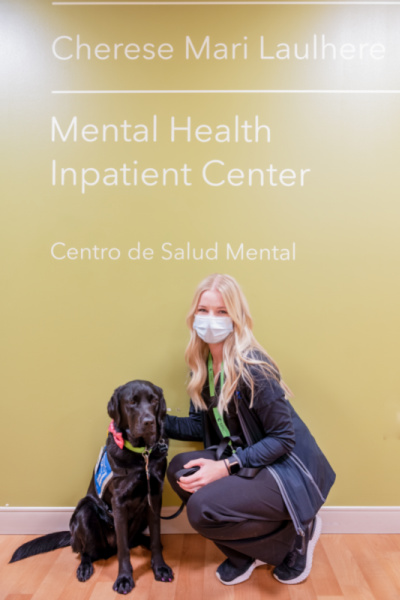 Black lab dog and blond woman 