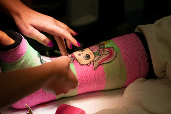 pink and green cast with doll image