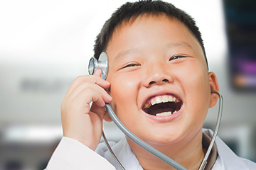 Kid with stethoscope and smiling