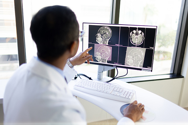 Dr. Magge, CHOC neurosurgeon, looks at brain scans on a monitor