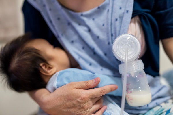 Mother breastfeeding and pumping