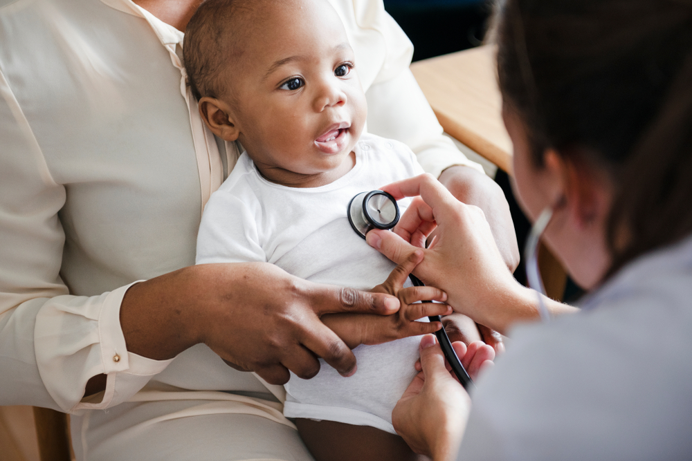 Baby being examined by doctor with stethoscope