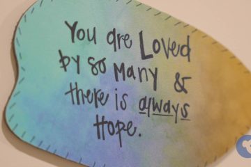 A colorful plaque that reads "You are Loved by so many & there is always Hope."